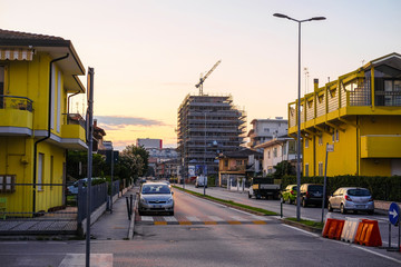 Sattomarina, Italy - August, 29, 2019: cars parking on the street in a center of Sattomarina, Italy at sunrise