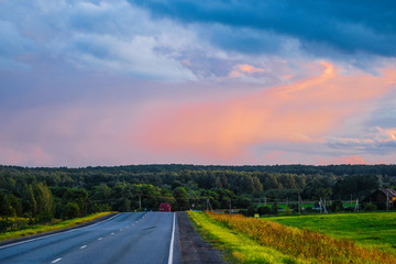Fototapeta na wymiar Moscow region, Russia - August, 9, 2019: Country road in Moscow region at sunset