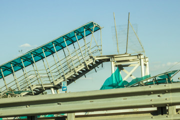 Broken overpass. The accident with a metal structure. Broken metal beams. The engineering solution could not stand the blow.