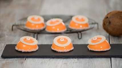 Cakes with mango and coconut in the mirror glaze.