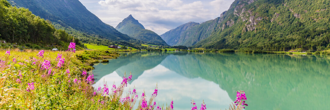 Mountain panorama with mountain Eggenipa reflecting in a lake in Gloppen along highway E39 in Sogn og Fjorden county in Norway
