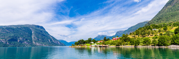 Fototapeta na wymiar View on Ornes, famous for Urnes Stave Church, from the liitle ferry crossing Lustrafjorden between Solvorn and Ornes, Sogn og Fjordane in Norway.