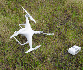 The crashed drone. Dirty and in the juice of the grass is a quad