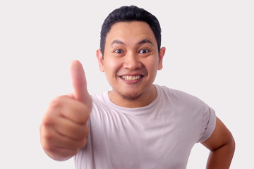 Fototapeta premium Young Man Showing Thumbs Up Gesture OK Sign