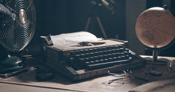 Light Revealing Typewriter. 1950s Scene Setup. Film or Movie Opening Shot 4K