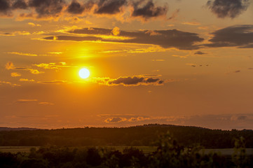 A beautiful sunrise with a golden sunshine on a late summer evening. Concept: landscape or sunset