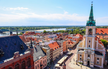 Aerial view of the Vistula ( Wisla ) river with bridge and historical buildings of the medieval city of Torun, Poland. August 2019