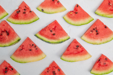 slices of fresh watermelon on a light background