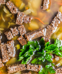 Soup with crackers and parsley
