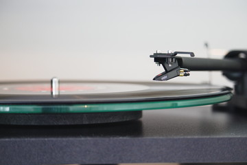 Recordplayer with stylus floating above a record