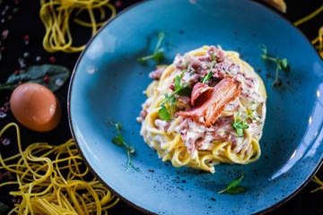 fresh italian spaghetti carbonara with tasty ingredients - cream, egg, bacon