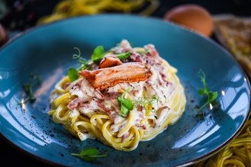 fresh italian spaghetti carbonara with tasty ingredients - cream, egg, bacon