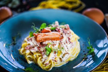 fresh italian spaghetti carbonara with tasty ingredients - cream, egg, bacon