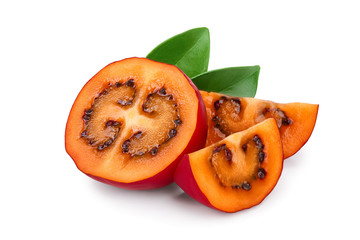 Fresh tamarillo half fruit with leaves isolated on white background