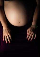 Pregnant Woman holding her tummy with 8 months pregnant