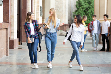 High school students walking out of college building together