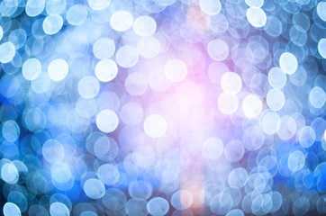 Defocused background of Christmas lights outdoors. Blurred lights background.