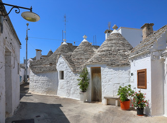 Street of a white Trulli houses. Apulia, Italy