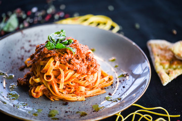 delicious italian spaghetti bolognese with minced beef sauce, tomatoes, carrots & fresh basil 