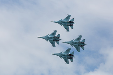 Four war jet planes in sky