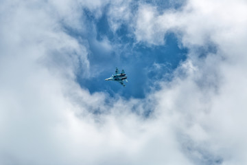 Fototapeta na wymiar War jet plane among cloudscape