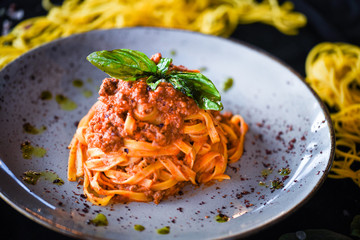 delicious italian spaghetti bolognese with minced beef sauce, tomatoes, carrots & fresh basil 