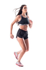 Sporty young athletic runner woman jogging with flying long hair. Full body isolated on white...