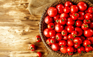 Fresh red tomatoes and wooden desk space 