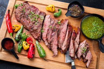 Modern design barbecue dry aged wagyu bavette de flanchet steak with chili and chimichurri sauce as...