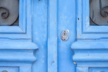 Blue painted door with windows and lock hole