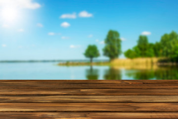 Naklejka na ściany i meble wooden table for advertising and presentation of your products, river background