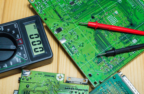 Services for the production of electronics and repair on a wooden background.