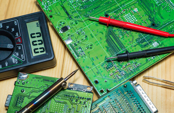 Services for the production of electronics and repair on a wooden background.