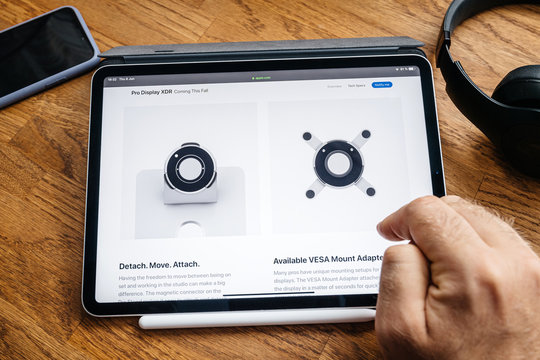 Paris, France - Jun 6, 2019: Man Reading On Apple IPad Pro Tablet About Latest Announcement Of At Apple Worldwide Developers Conference (WWDC) - Showing The Pro Display XDR Vesa And Stand