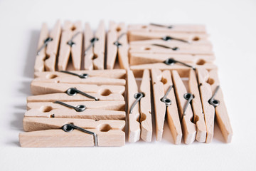 Wooden clothespins on a white background. View from above