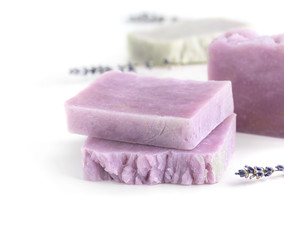 Handmade lavender soaps in a row on white background