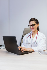 young doctor woman working on laptop at the consult. Modern Medical concept indoors