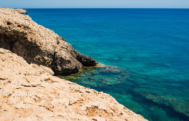  colorful pristine nature of the coast of Cyprus cape cavo greco with clear blue water and yellow rocks
