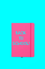 Back to school sign on pink notebook