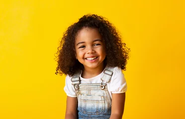 Foto op Plexiglas Happy smiling african-american child girl, yellow background © Prostock-studio