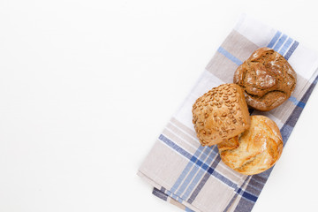 Gold rustic crusty loaves of bread and buns on wooden background. Still life captured from above top view, flat lay.