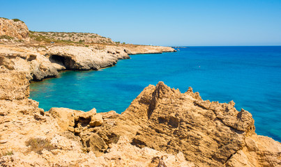  colorful pristine nature of the coast of Cyprus cape cavo greco with clear blue water and yellow rocks