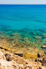  colorful pristine nature of the coast of Cyprus cape cavo greco with clear blue water and yellow rocks
