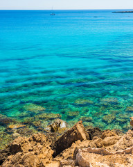  colorful pristine nature of the coast of Cyprus cape cavo greco with clear blue water and yellow rocks