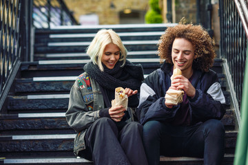 Fototapeta premium Happy couple eating Doner kebab, shawarma, in Camden Town