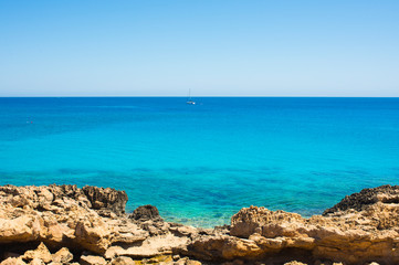  colorful pristine nature of the coast of Cyprus cape cavo greco with clear blue water and yellow rocks