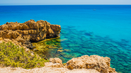  colorful pristine nature of the coast of Cyprus cape cavo greco with clear blue water and yellow rocks