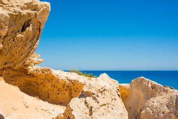  colorful pristine nature of the coast of Cyprus cape cavo greco with clear blue water and yellow rocks