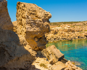  colorful pristine nature of the coast of Cyprus cape cavo greco with clear blue water and yellow rocks