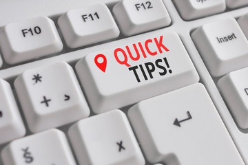 Handwriting text Quick Tips. Conceptual photo small but particularly useful piece of practical advice White pc keyboard with empty note paper above white background key copy space